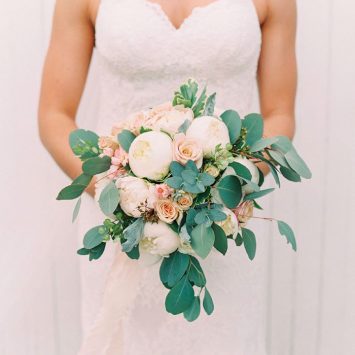 Natural hand tied bridal bouquet of white Peonies, peach Roses and Spray Roses - Wedding flowers by Rhiann. Stoke on Trent, Staffordshire